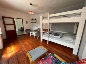 a room with two bunk beds and a living room at Apartmany u Synagogy in Třebíč