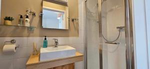 a bathroom with a sink and a shower at Halmer Grange Guest House in Goathland