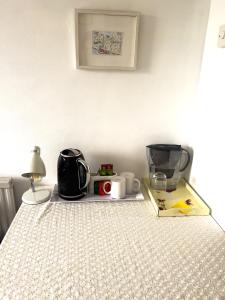 a counter top with a blender and other items on it at Charming and Cosy Canary Wharf Room with Stunning Views in London