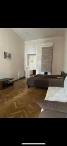 a large room with two beds and a window at Sweet Home Agmashenebeli in Tbilisi City