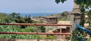a view of a village with a building on a hill at Maison de vacances vue sur la mer in Mazer
