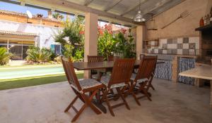 a dining room with a wooden table and chairs at 271 Cas Padri Teco ETV6178 by Mallorca Charme in Ariany