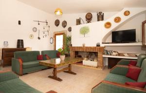a living room with green chairs and a fireplace at 273 Villa Joy ETV99 by Mallorca Charme in Llubí