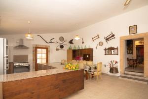 a kitchen with a counter and a dining room at 273 Villa Joy ETV99 by Mallorca Charme in Llubí