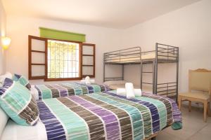 a bedroom with two bunk beds and a chair at 273 Villa Joy ETV99 by Mallorca Charme in Llubí +35 photos