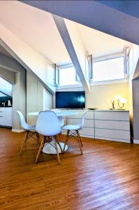 a dining room with a table and two chairs at Monza Apartments in Monza +46 photos