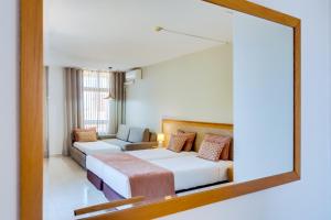 a bedroom with a bed and a mirror at Auramar Beach Resort in Albufeira