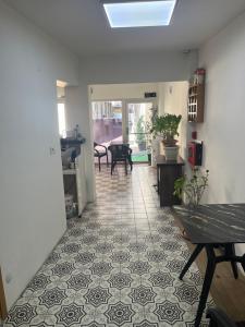 a living room with a tile floor and a table at Türkmen hotel in Istanbul