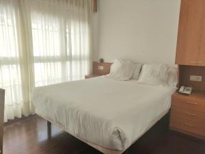 Łóżko lub łóżka w pokoju w obiekcie Hotel Hórreo by Bossh! Hotels