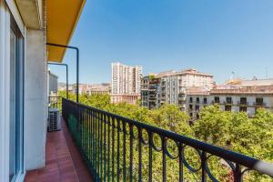 a balcony with a view of a city at Blueground La Dreta de lEixample elev washer BCN-150 in Barcelona