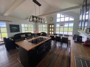 a kitchen and living room with a stove top at Myrarkot Country Home in Selfoss +21 photos