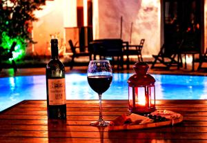 a bottle of wine and a glass on a table at Derin Apart Hotel Bodrum in Bodrum City +28 photos