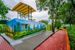 a building with a painting of trees on it at Nature Trails Durshet, Khopoli in Khopoli