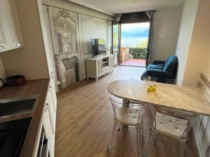 a kitchen with a table and a living room at Lago Bello in Stresa