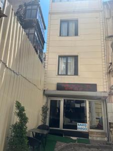 a building with a sign in front of a restaurant at Türkmen hotel in Istanbul