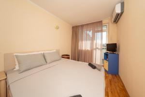 Ένα ή περισσότερα κρεβάτια σε δωμάτιο στο Boris Garden Comfort Suite