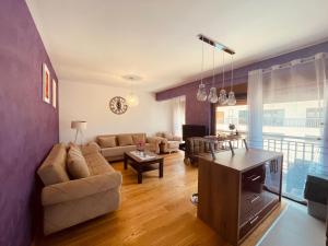 a living room with a couch and a table at Lavander Apartment W Pool and Private Beach in Tivat