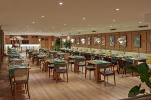 a restaurant with tables and chairs in a room at H10 Gran Tinerfe - Adults Only in Adeje
