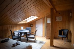 a room with a bed and a table and chairs at Doberek Noclegi w Beskidzie Niskim in Kobylanka
