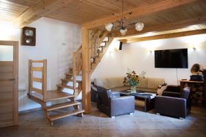 a living room with a staircase and a couch at Doberek Noclegi w Beskidzie Niskim in Kobylanka