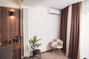 a living room with a chair and a window at Hotel Tazz - River Front Oasis Collection in Bihać