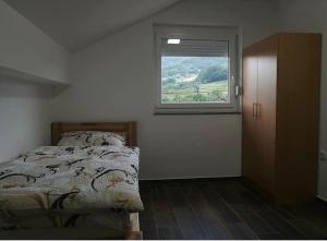 a bedroom with a bed and a window at Sobe Dado, Gostionica Kod Dade in Banja Luka
