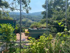 a person laying in a hot tub in a garden at Casa Luna in Prunetto
