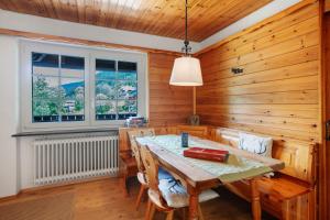 a wooden dining room with a wooden table and chairs at Familien-Sportappartements Wetzel in Menzenschwand