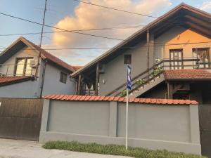 a house with a fence and a flag in front of it at Apartman Djokic 1 in Požarevac