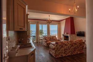 a kitchen and living room with a couch and chairs at Anna Apartments Boukari in Boukari