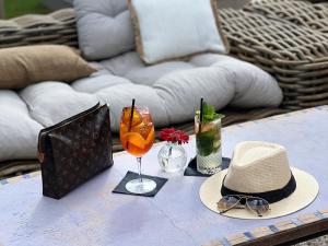a table with a hat and glasses on top of it at L'Intemporel in Saint-Cyr-sur-Mer
