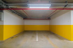 an empty parking garage with yellow and white walls at Flexible SelfCheckIns 93 - Zagreb - Garage - Balcony - Bedroom in Zagreb +14 photos