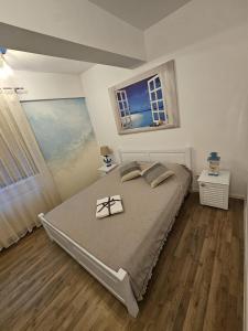 a bedroom with a bed with a pair of glasses on it at Apartament modern 2 camere,complet utilat,cu balcon si Vedere la mare-Zoorba in Mamaia Nord