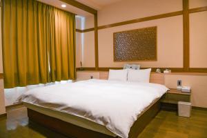Postel nebo postele na pokoji v ubytování Hotel HERB ホテルハーブ大人用