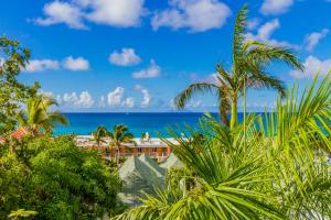 a view of the ocean from a resort with palm trees at La Vista Resort in Simpson Bay