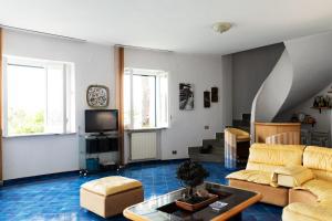 a living room with a couch and a tv at Villa Anna Maria Positano in Positano