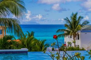 a swimming pool with a view of the ocean at La Vista Resort in Simpson Bay