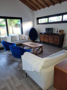 a living room with a couch and blue chairs at Maison familiale in Le Teich