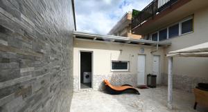 a house with a bench in front of a wall at Le Case Di Nonna Angela in Matera