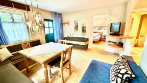 a living room with a table and a couch at Romantikchalet in Breitenbrunn