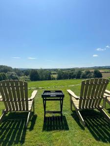 two chairs and a table in a field at Charingworth Manor in Chipping Campden