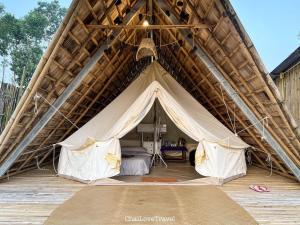 a tent with a bed inside of it at Fuang Dao Mountain Resort in Muang Fuang