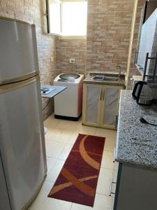 a kitchen with a sink and a refrigerator at بورتو مارينا ريزدنس in El Alamein