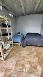 a room with two beds and a bunk bed at Saenz Peña x 4 in Venado Tuerto