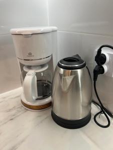 a coffee maker sitting on a counter next to a coffeemaker at Mikołowska Small Heaven - free underground parking in Katowice