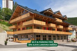 een gebouw met een bord ervoor bij Residence Post in Pec pod Sněžkou