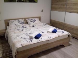 a bedroom with a bed with two pillows on it at Apartment Center Njivice in Njivice