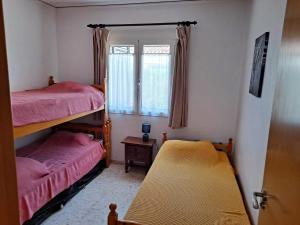 a bedroom with two bunk beds and a window at Denia El Palmar 183 in Denia +20 photos