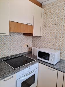 a kitchen with a microwave and a counter top at Denia El Palmar 183 in Denia