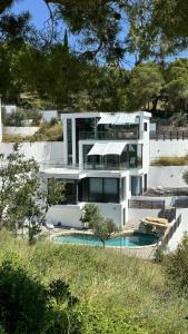 a large white house with a pool in front of it at WELCS VILLA DE LUJO 177 EMP con piscina privada in Llança